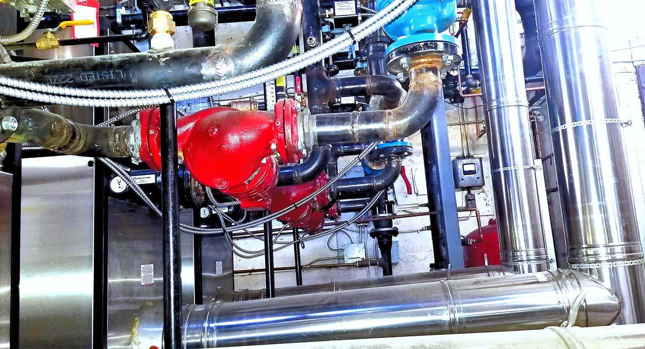 Series of pipes and vents in a boiler room
